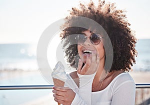 Summer is for indulging in all the desserts. a young woman enjoying an ice cream cone outdoors.