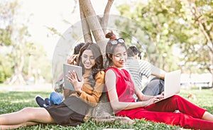 Group of students or teenagers with laptop and tablet computers hanging out