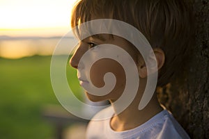 Summer joy for cute kid at the backlit sunset