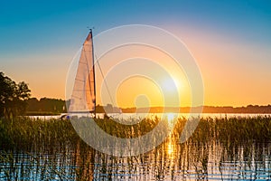 Summer joy in lake with yacht at sunset