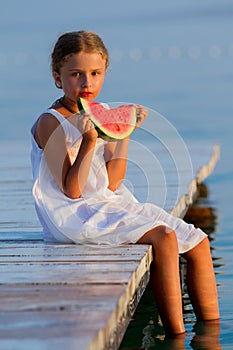 Summer joy, lovely girl eating fresh watermelon on the beach