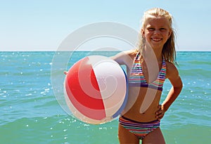 Summer joy - young girl enjoying summer. Girl with ball.