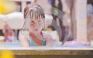 Summer kid holiday in the water. Little child girl in  the water pool