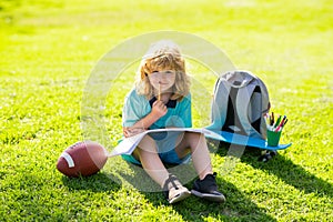 Summer kids leisure. Child learning outside in the nature park. Relaxation and childhood concept. Little boy with brush