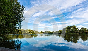 Summer lake landscape with green trees and bush, Woking, Surrey