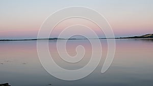 Summer lake. Panoramic view of old fishing boats. View of sunset