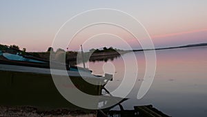 Summer lake. Panoramic view of old fishing boats. View of sunset. Low DOF