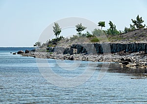 Summer landscape with dolomite rocks by the sea, beautiful view of wild romantic coastal cliff landscape at the Baltic Sea at