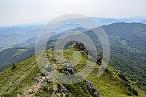 Summer landscape with forested hills and clouds in the sky above the valley. Carpathian mountains, Ukraine