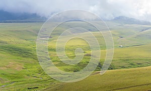 Summer landscape with green hills and cloudy sky. Plateau Assy, Kazakhstan