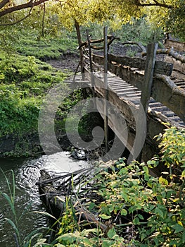 Beautiful  river  and old wooden bridge in the wood