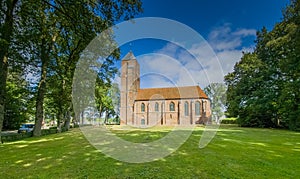 Summer landscape with historic landmark the Clemenskerk at Havelte