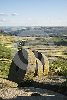Summer landscape image of millstones on top of Stanage Edge in P