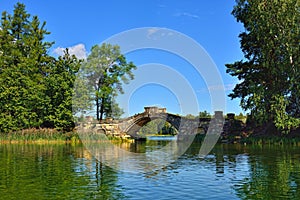 Summer landscape with lake and bridge in Gatchina park,