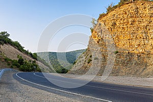 summer landscape mountain road with a sharp turn and descent
