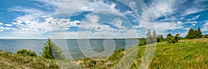 summer landscape. panoramic view of the lake under a beautiful cloudy sky with a coast in the foreground