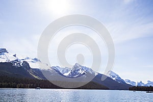 Summer landscape and people kayaking and fishing in Maligne lake, Jasper National Park, Canada