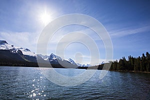 Summer landscape and people kayaking and fishing in Maligne lake, Jasper National Park, Canada