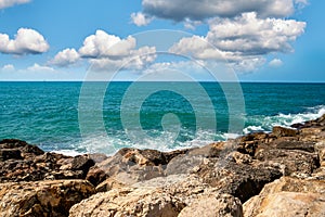 Summer landscape with rocks on the seaside, sea and sky