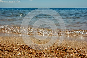 Summer landscape with sea waves lapping at the seashore.