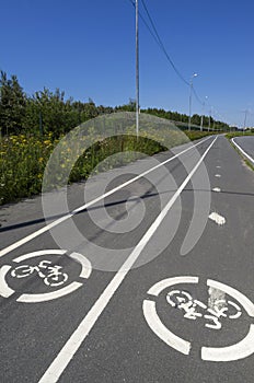 Summer landscape with two road signs `Bicycle path`