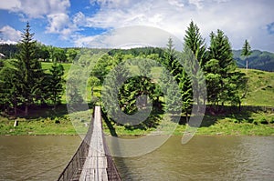 Summer landscape. Wooden Bridge over the river - Romania