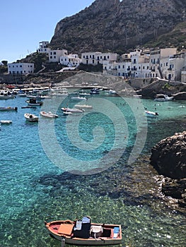 Summer landscapes from Levanzo, Sicily, Italy. Holidays in Sicily. Clear water, floating boats near the shore.