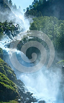 Summer Latefossen waterfall on mountain slope (Norway).