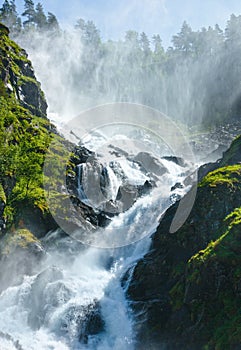 Summer Latefossen waterfall on mountain slope (Norway).