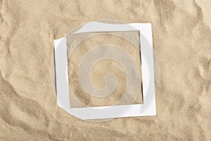 Summer layout, top view minimal design of beach sand with an empty paper frame