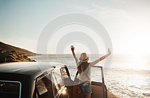 Summer, let the fun begin. a young woman enjoying a road trip along the coast.