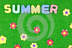 Summer lettering on a green background with flowers