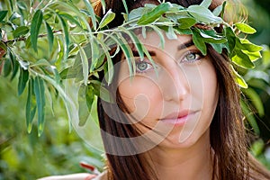 Summer lifestyle portrait of beautiful romantic girl holding bouquet of wild flowers