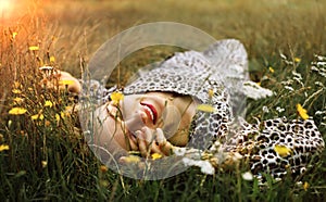 Summer lifestyle portrait middle aged woman lying on the grass outdoor. spends time in nature in summer.