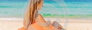 Summer lifestyle portrait of pretty girl sitting on the orange inflatable sofa on the beach of tropical island. Relaxing