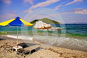 Sun umbrella and beds at Milia beach, Skopelos, Greece photo