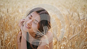 Summer model enjoying windy weather rye meadow closeup. Satisfied woman resting
