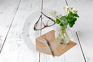 Summer mood with white clover on wooden table photo