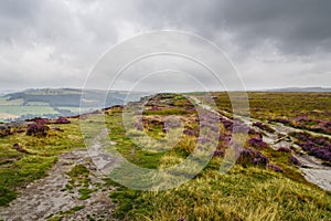 On a summer morning dark clouds and mist hang lay over the Derbyshire Peak District