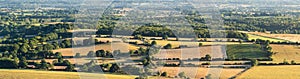 Summer morning landscape panorama view across rolling fields of South Downs National Park in England