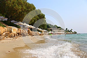 Summer morning sandy Sani beach with sunbeds and sunshades Chalkidiki, Greece. Sanny day