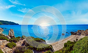 Summer morning sunshiny sandy beach and rocky coast near Platanitsi Beach, Sithonia Peninsula, Chalcidice, Greece