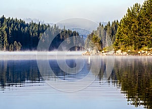 Summer mountain lake theme with cloudy blue sky