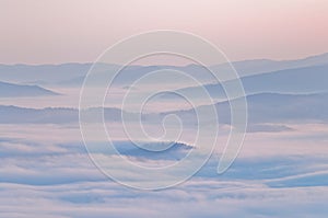 Summer mountain landscape with the sea fog