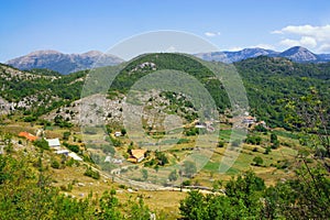 Summer mountain landscape with small village in valley. Sunny day in Dinaric Alps, Montenegro