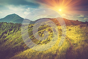 Summer mountain landscape at sunshine. Hiking trail in the hills.