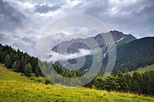 Summer mountain landscape with thunderstorm clouds. Location place Alps, Europe