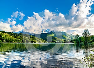 Summer mountain's lake landscape over blue sky before sunset.