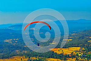 Summer mountain valley paragliding scene,Paragliding pilots focus on sky flight in saputara india,ountain valley paragliding,