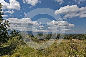 Summer mountains green grass and blue sky with clouds.